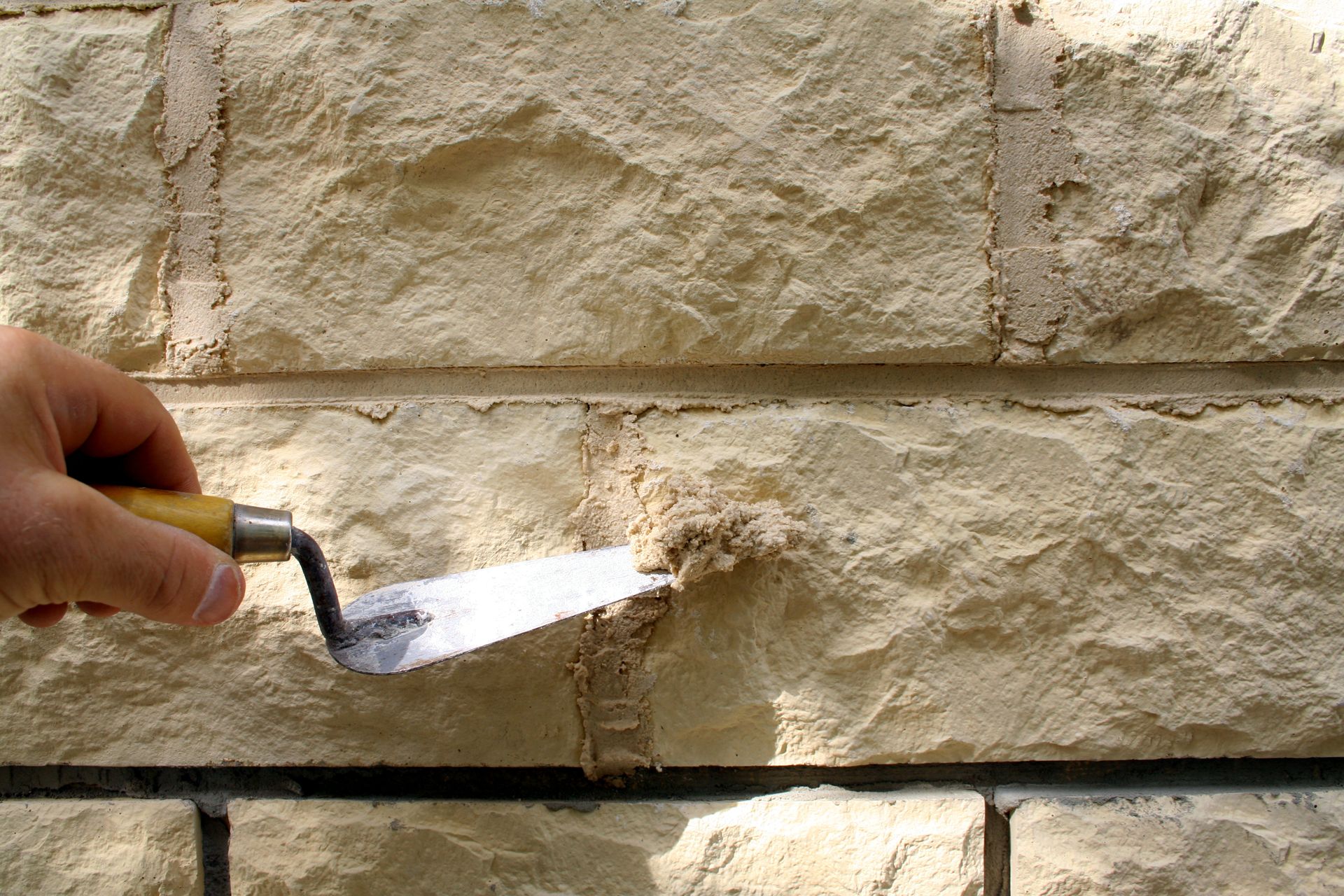 Finition à la truelle d'une façade en pierre