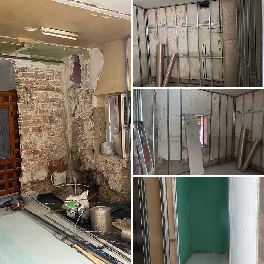 Proyecto de renovación: una habitación con pared de ladrillo a la vista, estructura de metal, instalación de paneles de yeso y pared terminada.