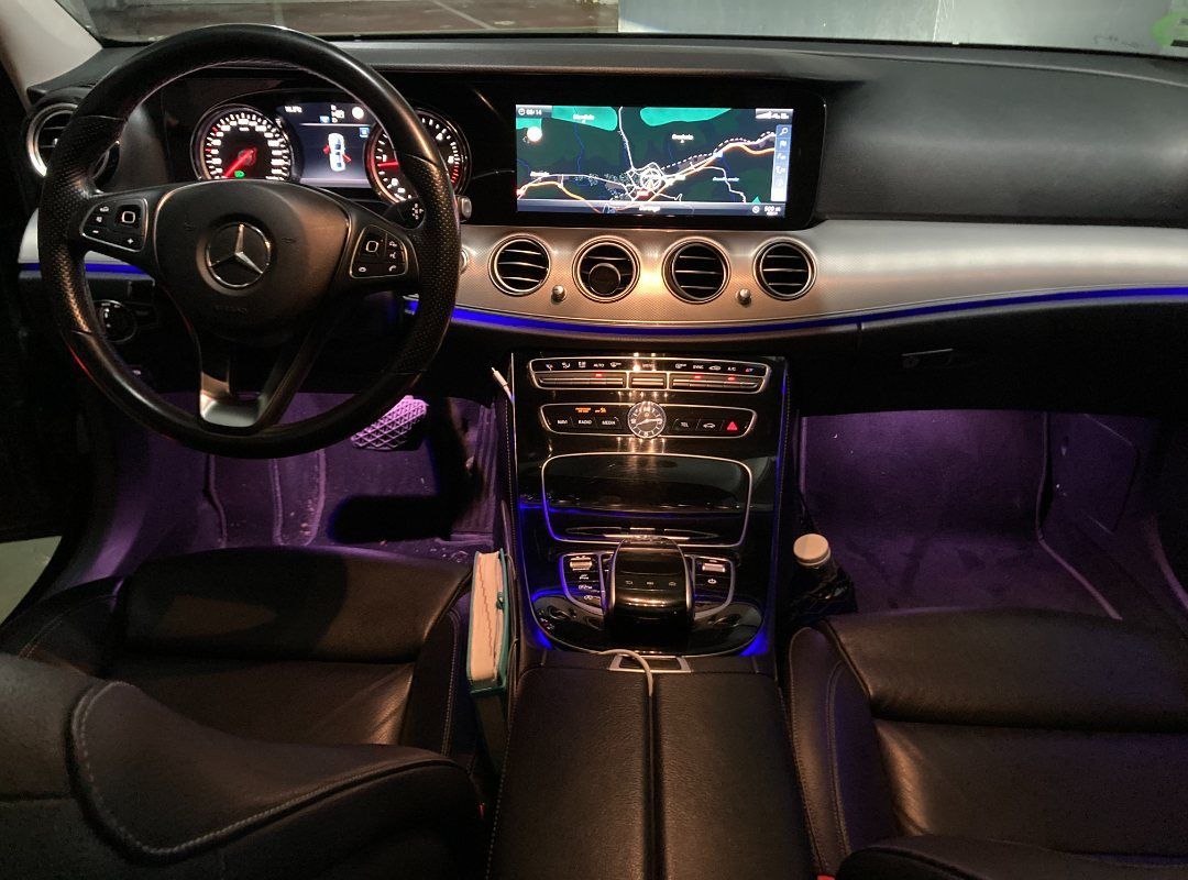 El interior de un Mercedes Benz Clase E con luces violetas.