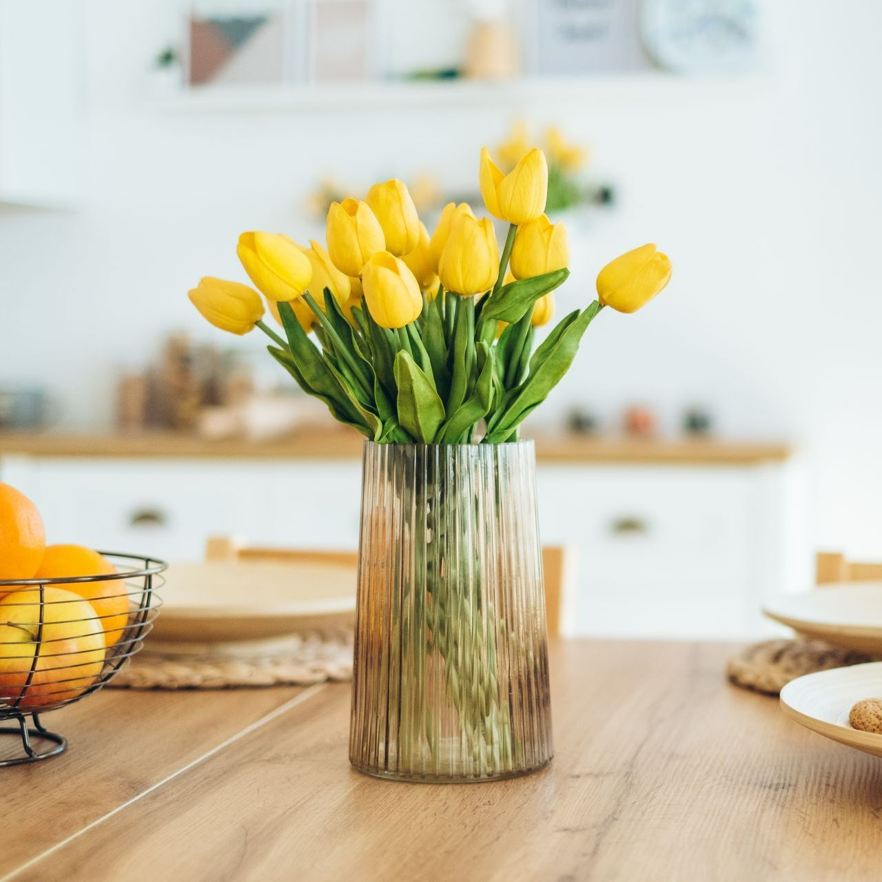 Vase transprent avec des tulipes jaunes