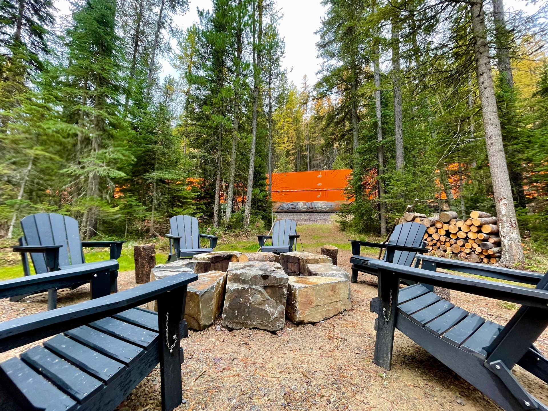 Beautiful Cabin in the woods, with train watching, Great Northern Getaway Cabin located between West and East Glacier Park entrances, perfect place to adventure inside and out of the Park, with stone fire pit