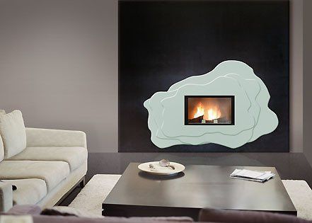 Salon moderne avec un mur sombre, un canapé blanc, une table basse et une cheminée encastrée dans un entourage en pierre.