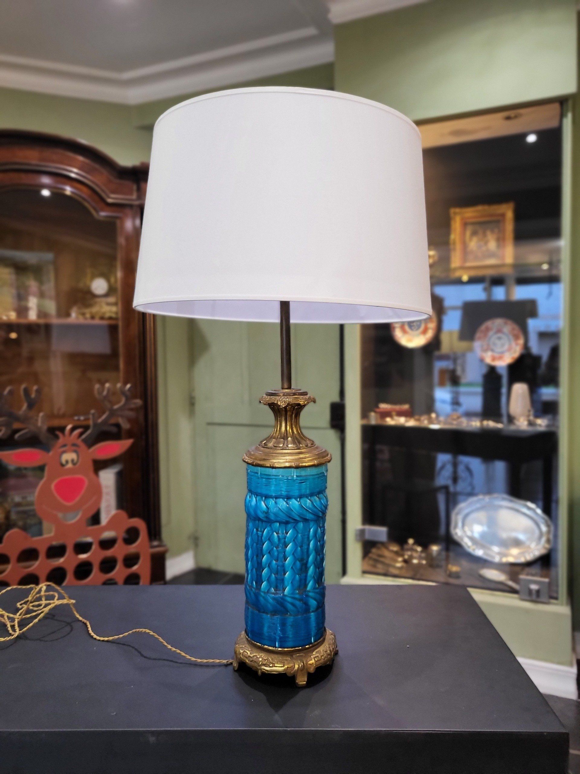 Lampe bleu et dorée avec un abajour blanc