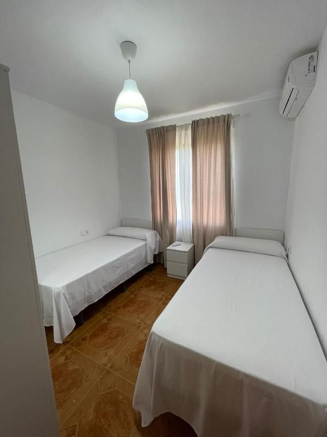 Un dormitorio con dos camas y una ventana.