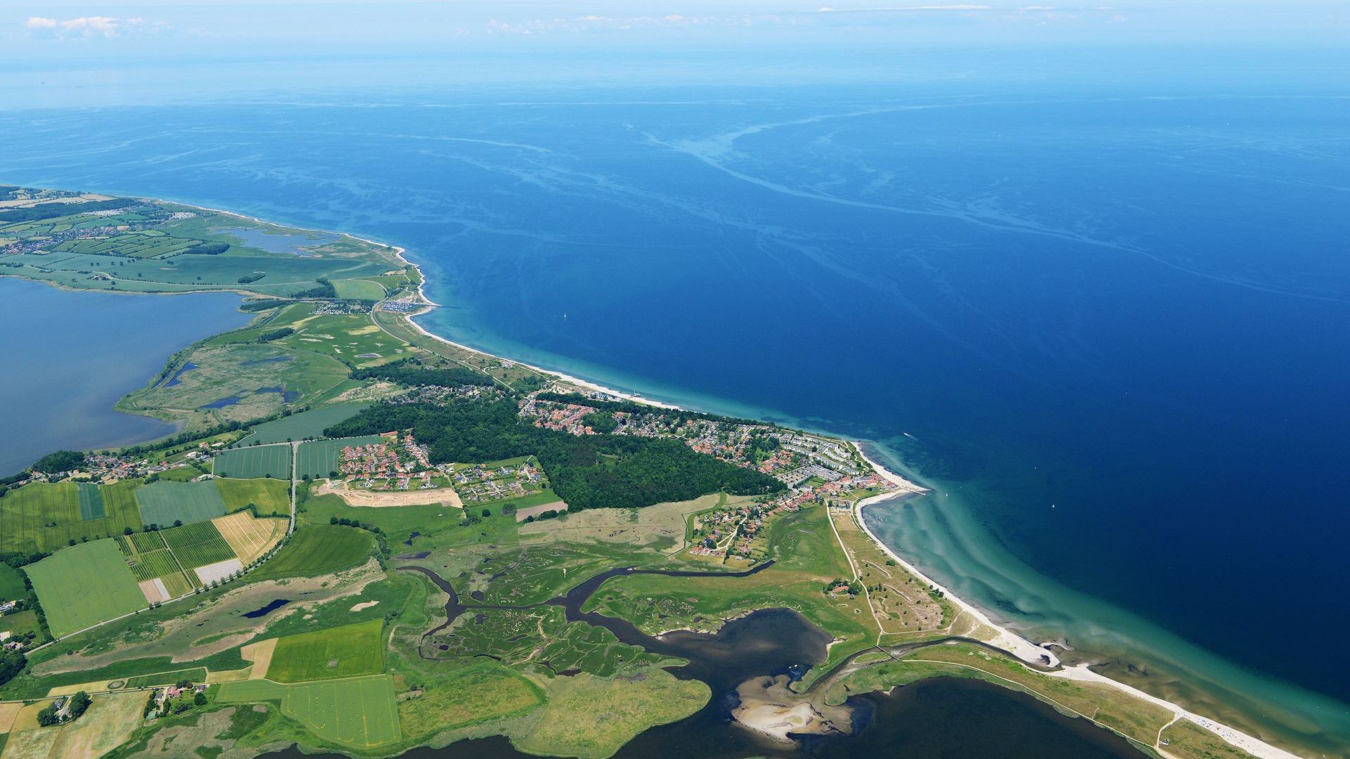 An aerial view of a small island in the middle of a large body of water.