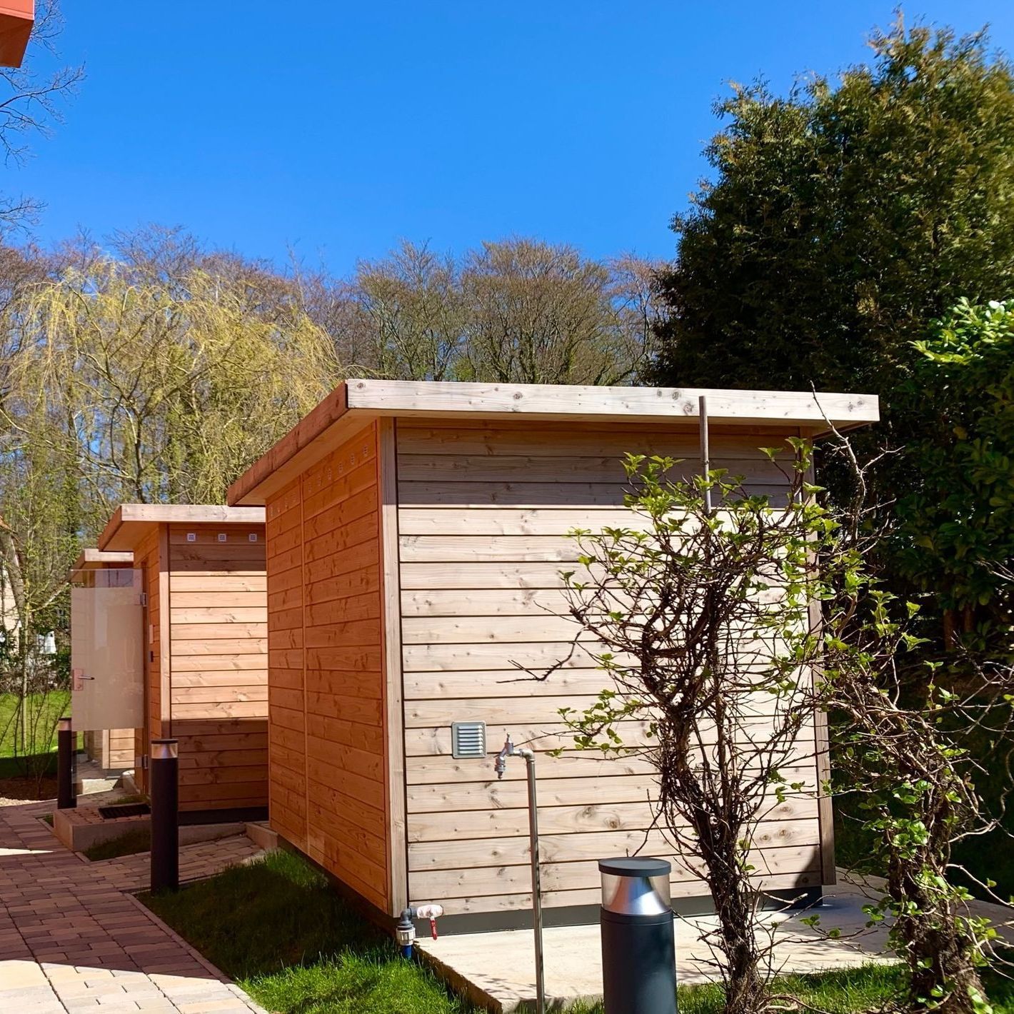 A small wooden shed with a blue sky in the background
