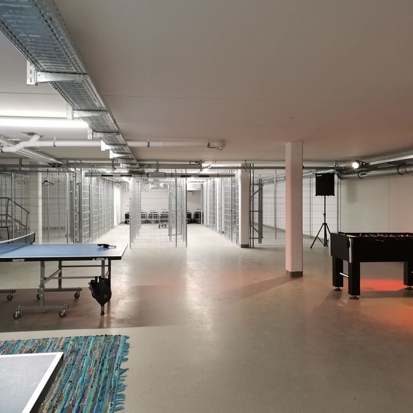 A large room with a ping pong table and a pool table
