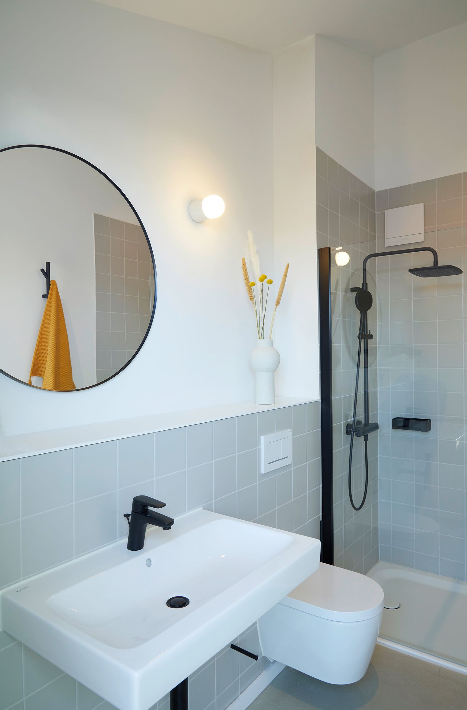 A bathroom with a toilet , sink and mirror