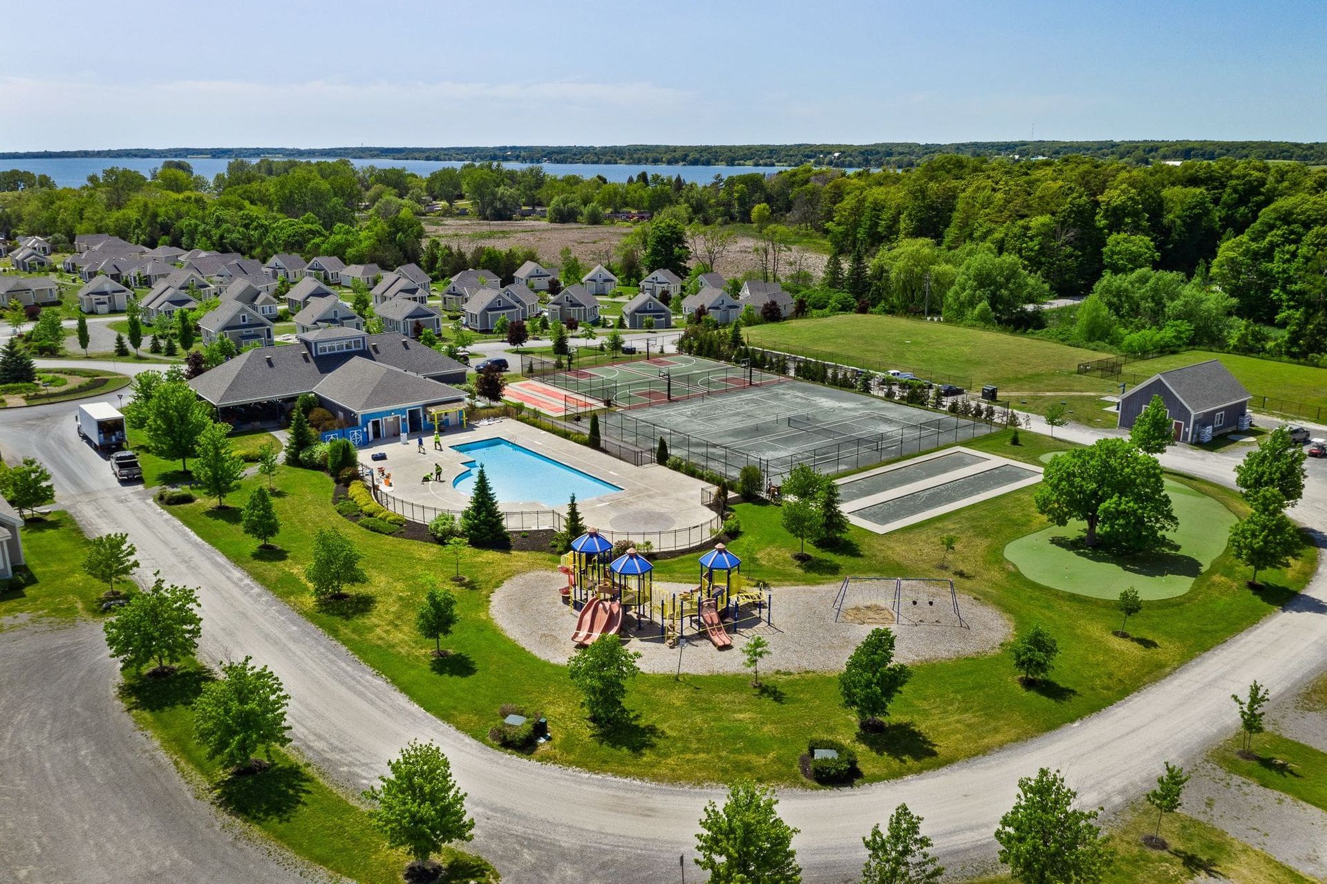 An aerial view of a residential area with a swimming pool and playground