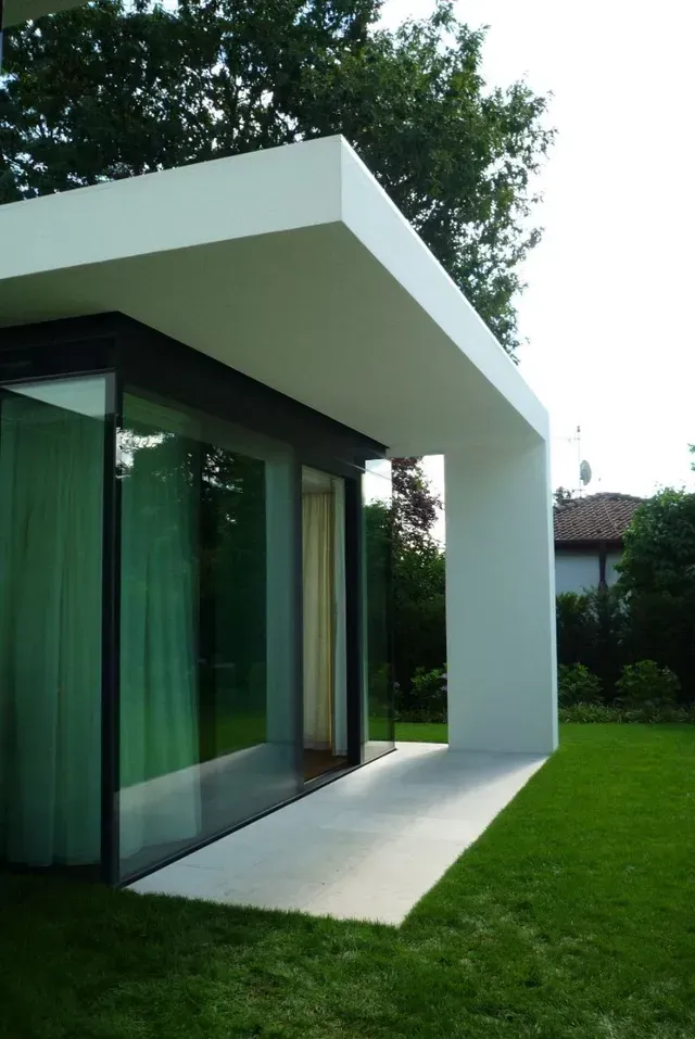 Ein weißes Gebäude mit einem Glasdach vom Hausgarten in Erlangen