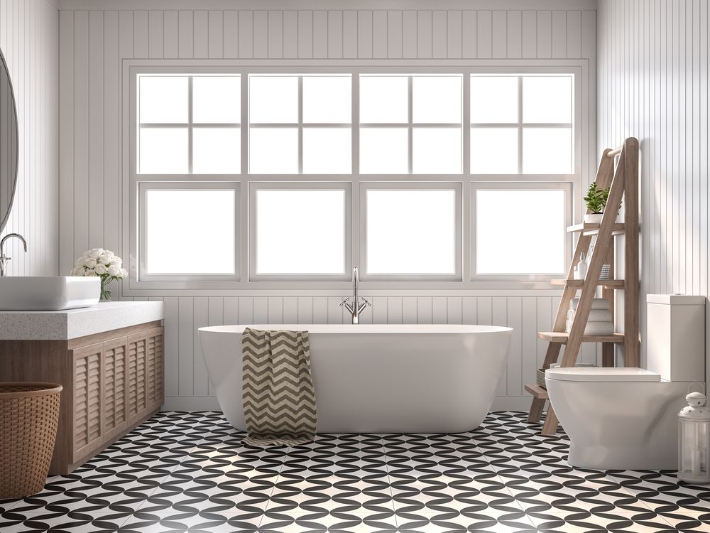 Un baño con bañera, inodoro, lavabo y espejo.