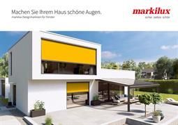 Ein weißes Haus mit einer gelben Markise an der Seite.