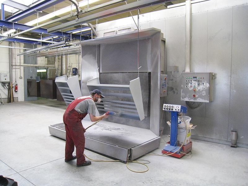 Ein Mann im Overall arbeitet an einer Maschine in einer Fabrik