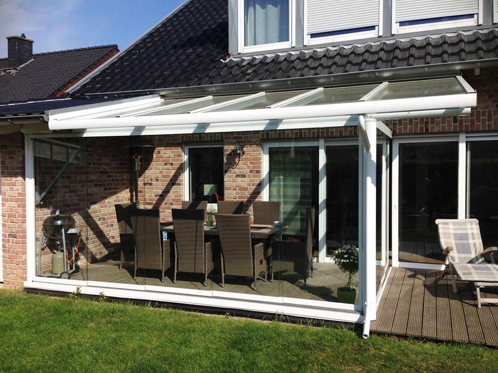 Eine Terrasse mit Tisch und Stühlen vor einem Haus