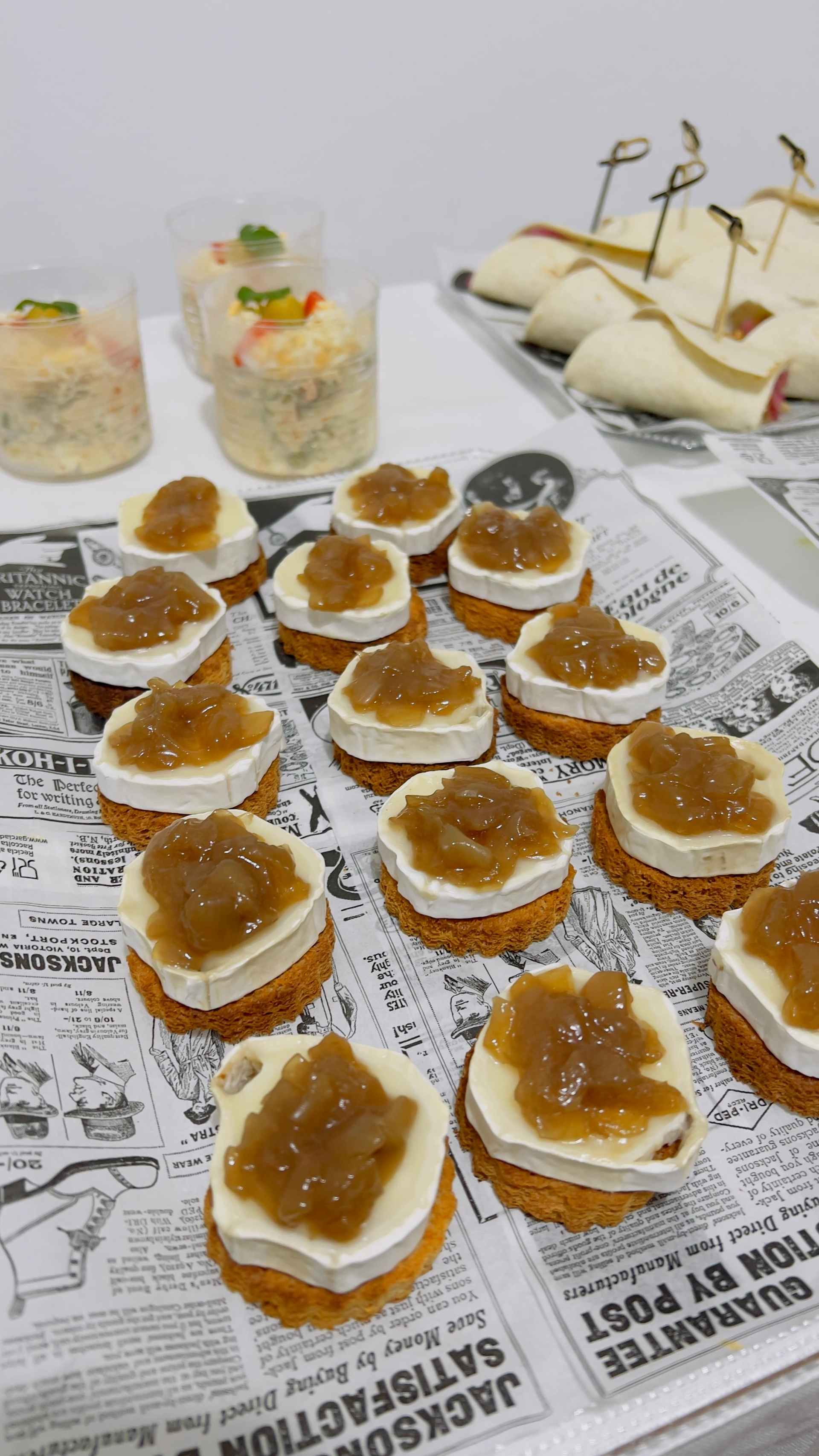Variedad de aperitivos del tamaño de un bocado sobre una mesa cubierta con papel de periódico.