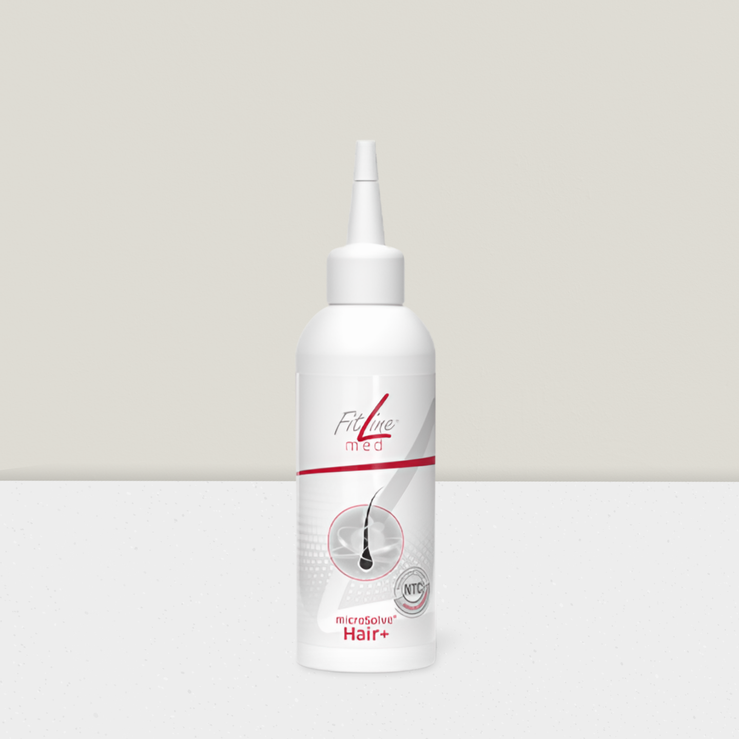 Haarsträhne mit goldenen Öltropfen.