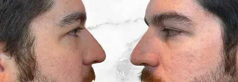 Un hombre con barba está mirando la cara de otro hombre.