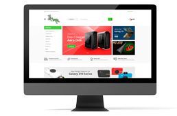 Ordenador de sobremesa mostrando una página web de compras en una pantalla blanca.