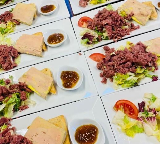 Assiettes de salade, pâté, pain grillé et chutney, disposées pour le service.