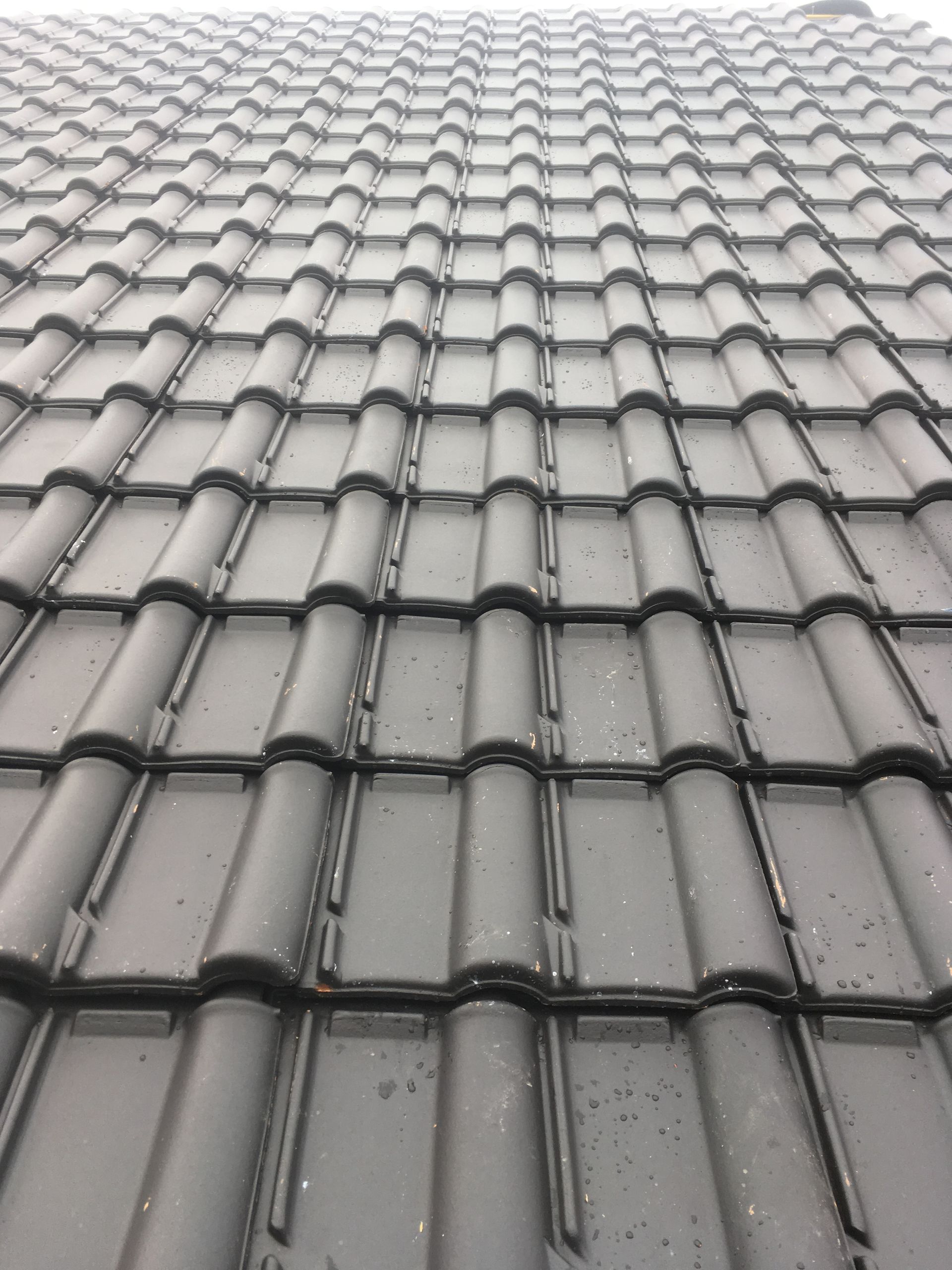 Une toiture en tuiles noires.