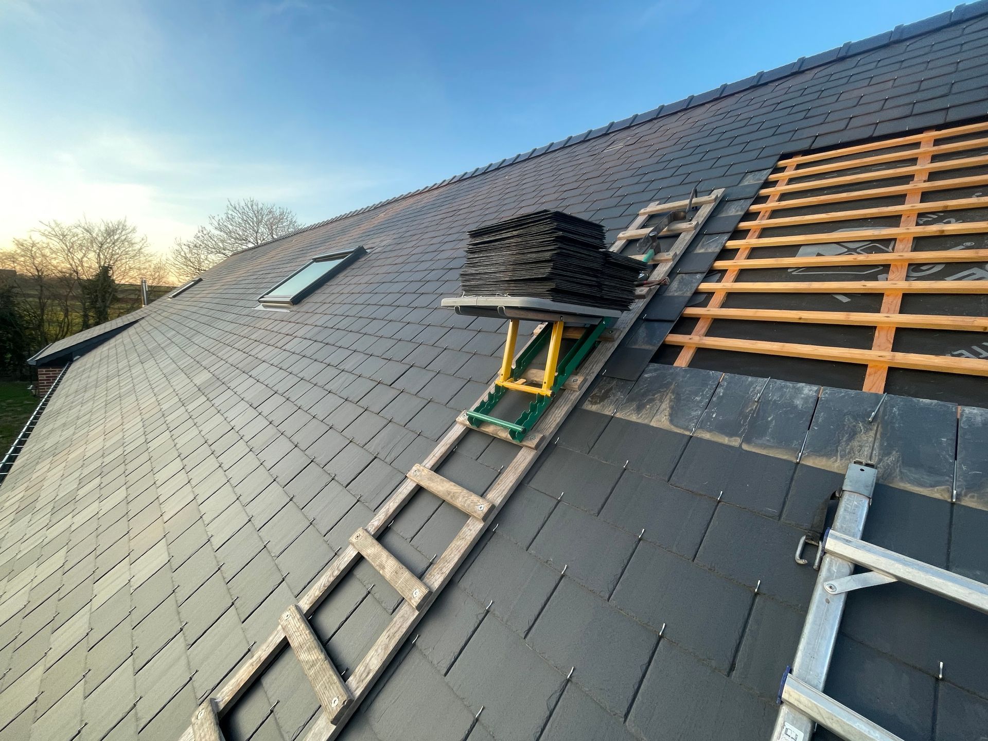 Rénovation d'une toiture avec fenêtre de toit.