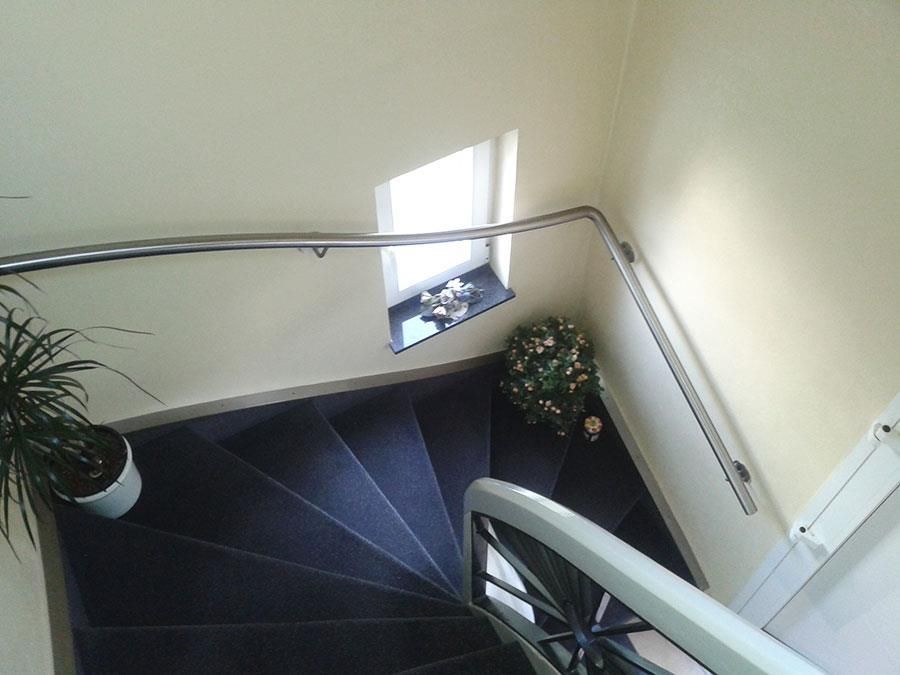 Eine Wendeltreppe mit einer Topfpflanze auf der Unterseite