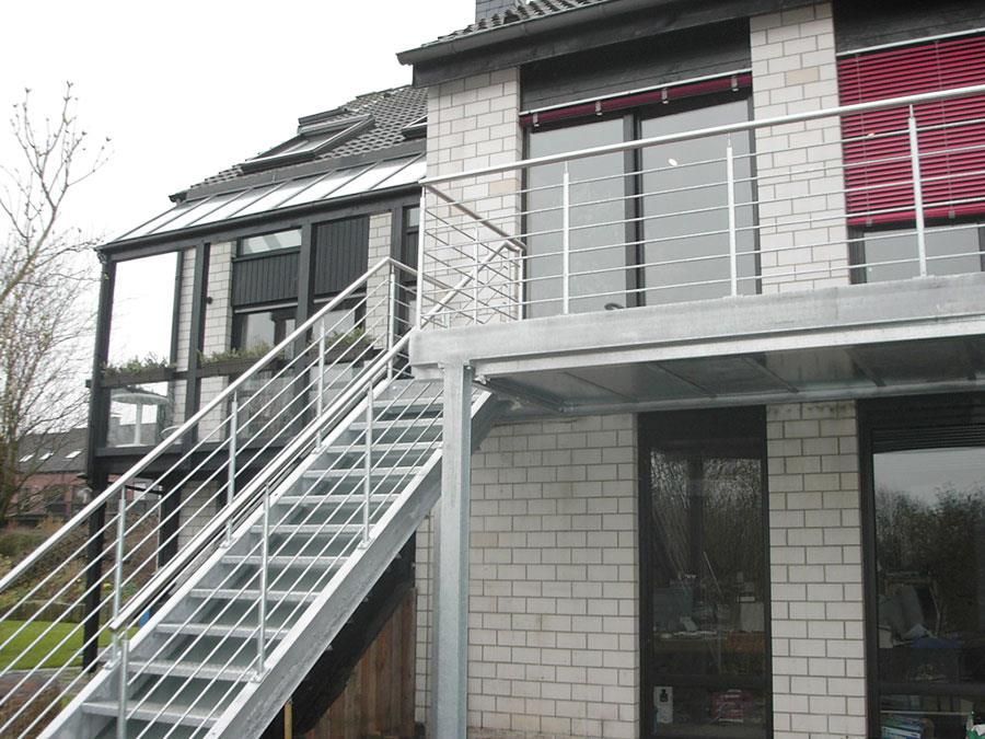 Ein Haus mit einem Balkon und einer Treppe, die dorthin führt