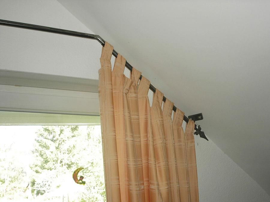 Ein Fenster mit einem Vorhang, der von der Decke hängt