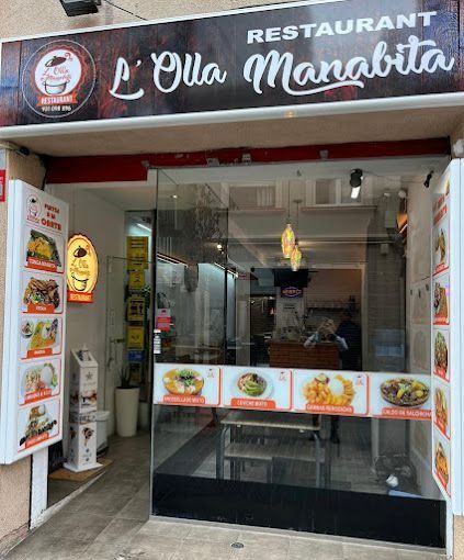 El frente de un restaurante con un cartel que dice l'olla mangbita.