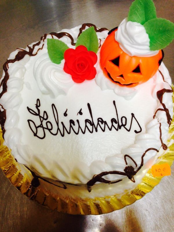 Un pastel blanco con la palabra felicidad escrita en él.