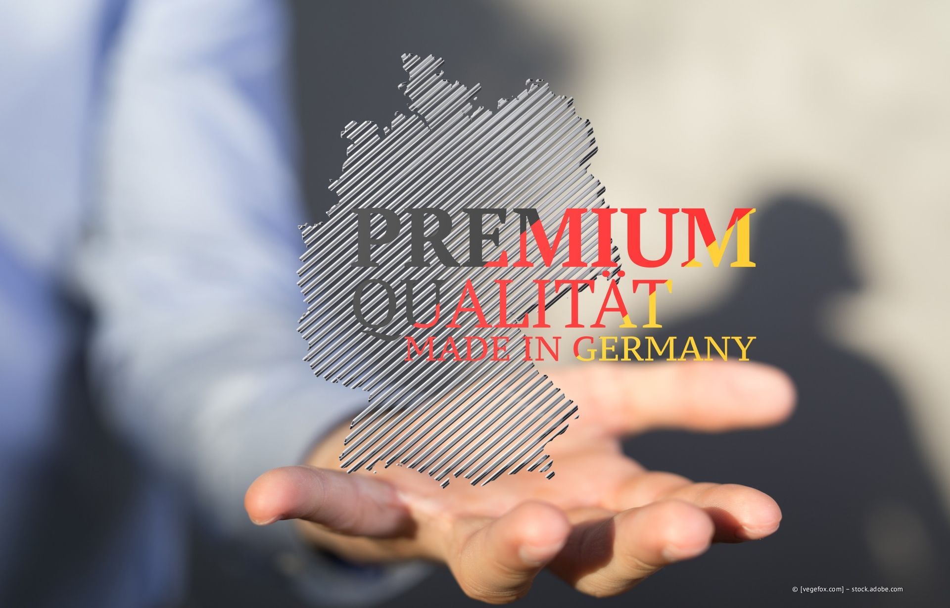 Hand hält eine Deutschlandkarte mit dem Text „PREMIUM QUALITÄT MADE IN GERMANY“.