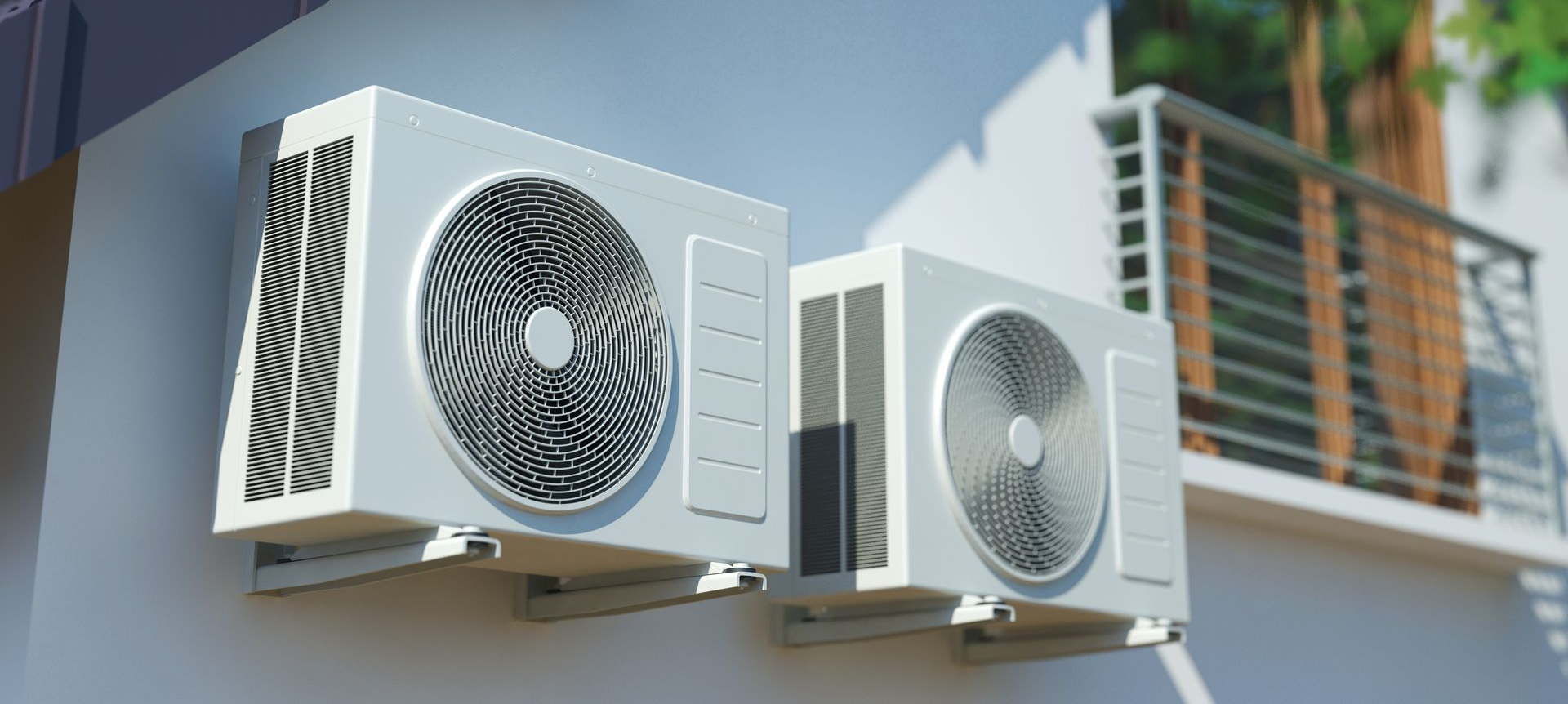 Deux unités de climatisation montées sur un mur extérieur.