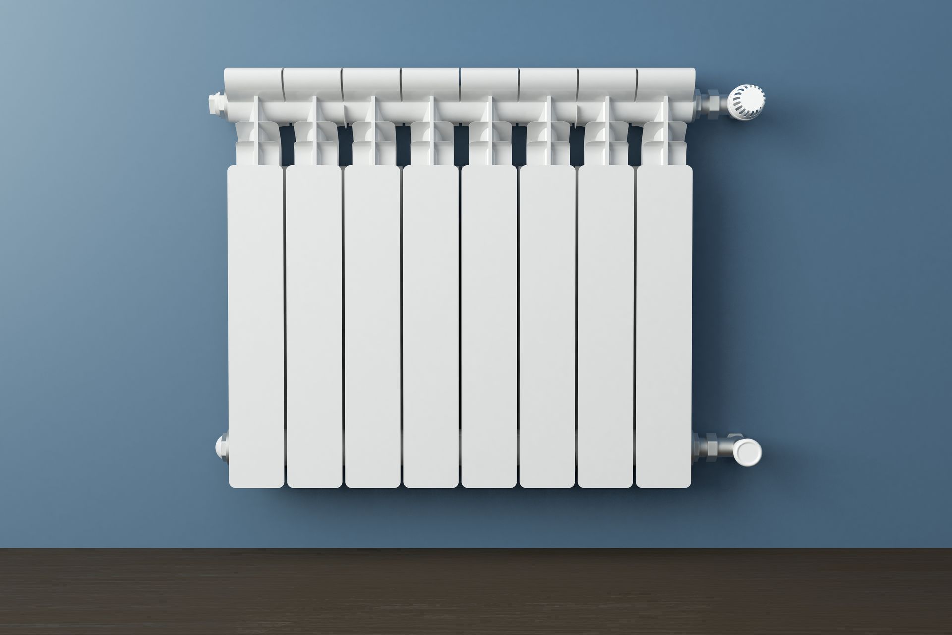 Radiateur blanc sur un mur bleu.