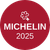 Een rood, rond logo met een wit Michelin-sleutelsymbool boven de tekst