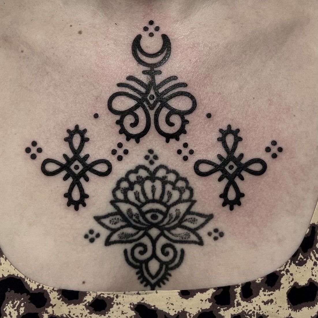 Una mujer tiene un tatuaje en blanco y negro en el pecho.