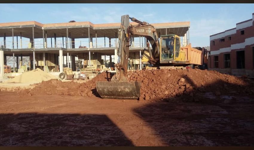 Un sitio de construcción con un gran edificio al fondo