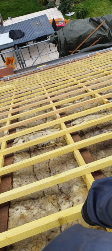 Poutre de charpente au-dessus d'une couche de laine de verre