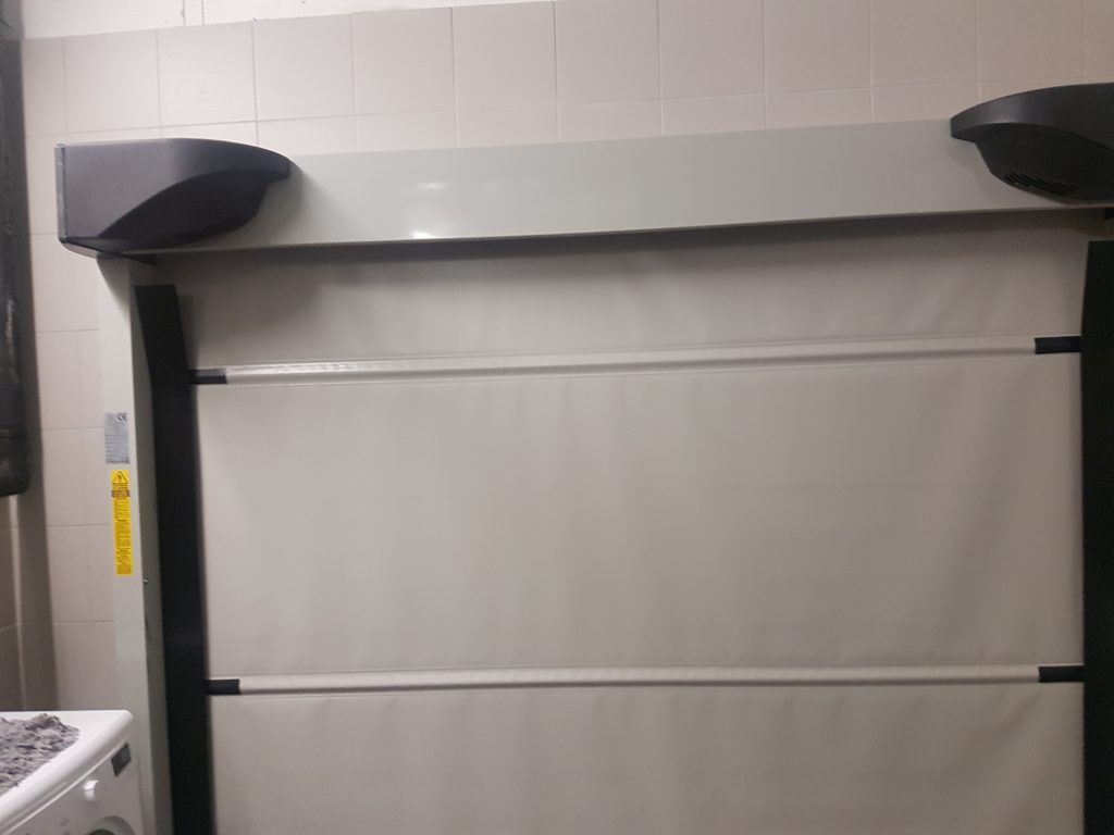 Mécanisme de motorisation d'une porte industrielle