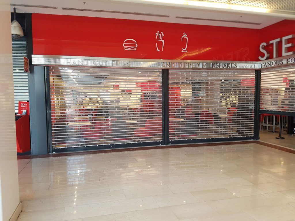 Un restaurant fermé avec une grille métallique