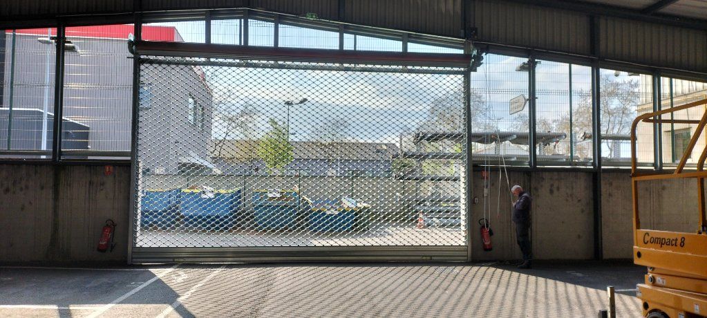 Un homme ouvre un rideaux métallique