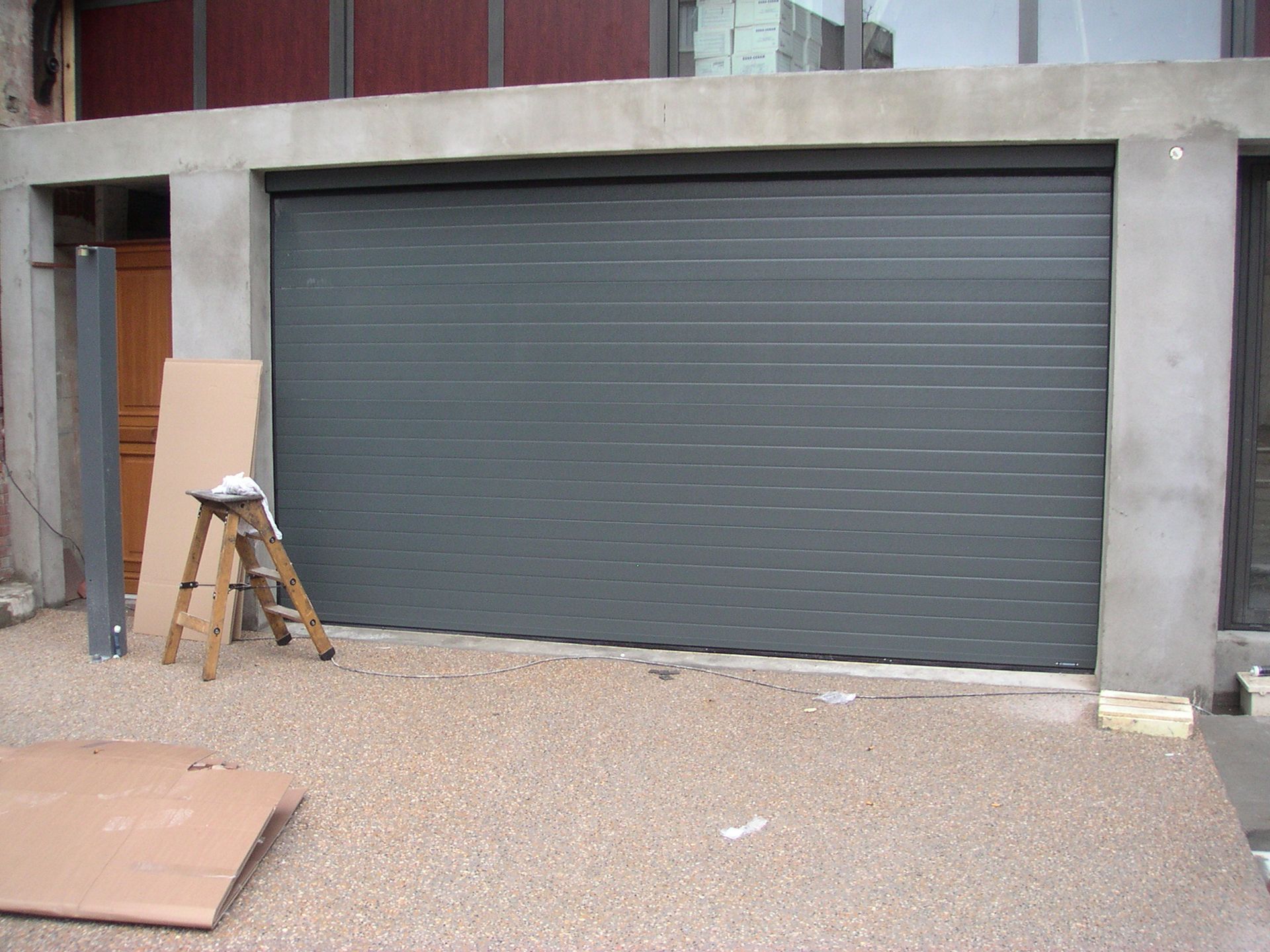 Une porte de garage fermée en alu foncé