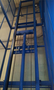 Una estructura de metal azul en un edificio con una pared de vidrio.