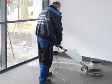 Mann reinigt den Boden mit einem professionellen Gerät