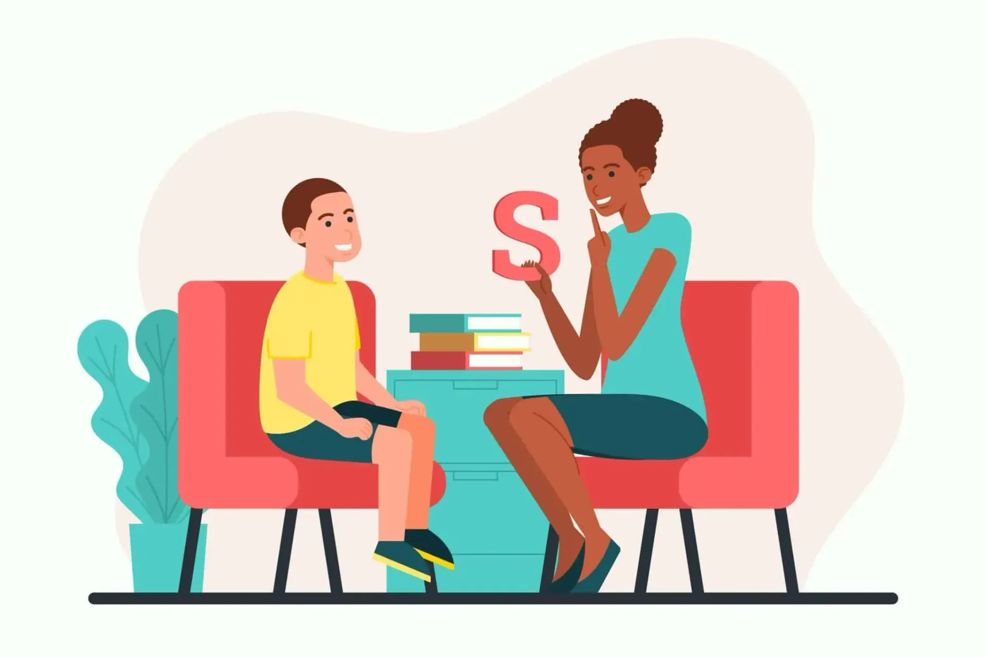Terapeuta y niño conversando en un sofá, con libros y una letra S roja entre ellos.