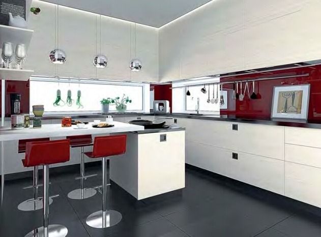 Cocina moderna blanca con detalles en rojo, isla con asientos y armarios empotrados.