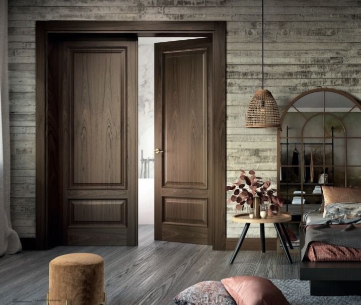 Sala de estar rústica con puertas dobles de madera abiertas, paredes grises, lámpara colgante tejida y acogedora zona de estar.