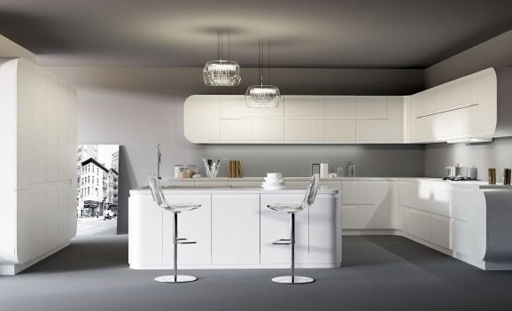 Cocina moderna blanca con isla, taburetes de bar, lámparas colgantes y armarios minimalistas.