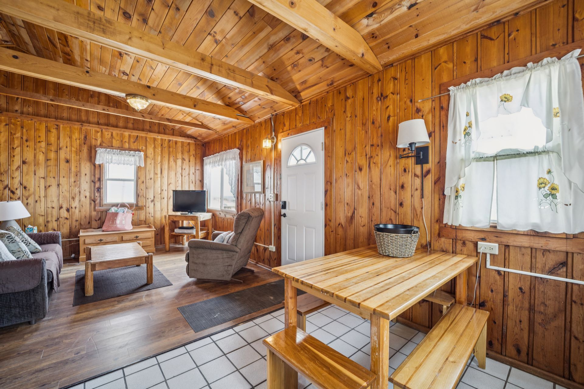 A living room with a chair and a flat screen tv