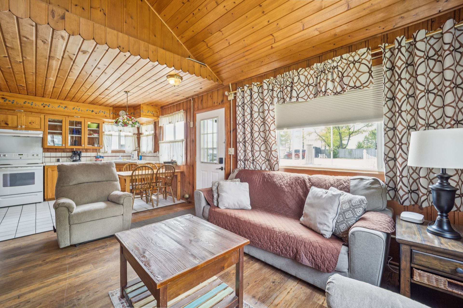 A kitchen with wooden cabinets and a wooden table.