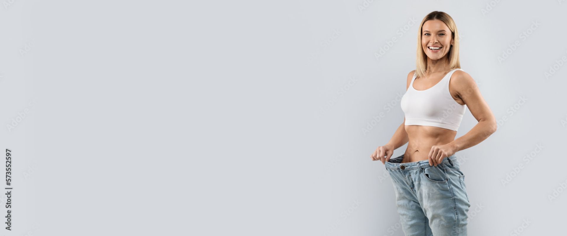 Frau hält Hosenbund nach Gewichtsabnahme